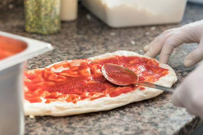 Cropped hand of person holding pizza