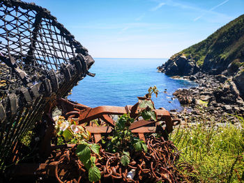 Scenic view of sea against sky with fishing net in the foreground 