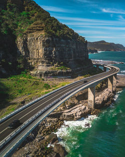 Aerial view of bridge over sea against sky