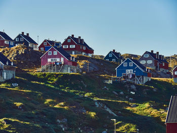 Houses and buildings against clear sky