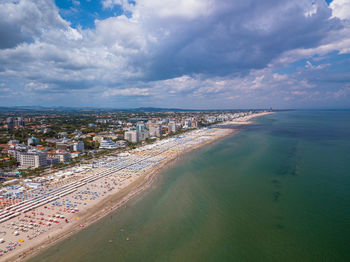 High angle view of sea and buildings against sky