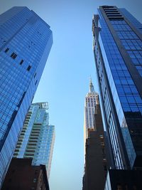 Low angle view of skyscrapers against clear blue sky