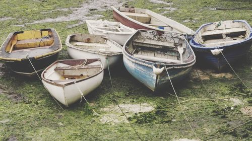 High angle view of abandoned boats moored on field