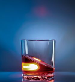 Close-up of glass against blue background