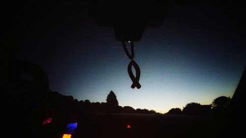 Silhouette trees against sky at night