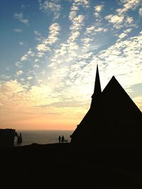 Silhouette of built structure at sunset