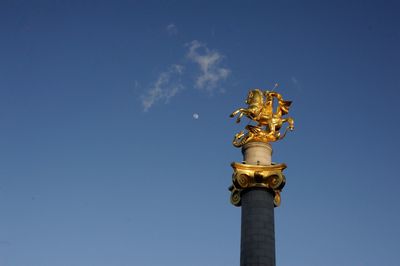 Low angle view of statue against sky
