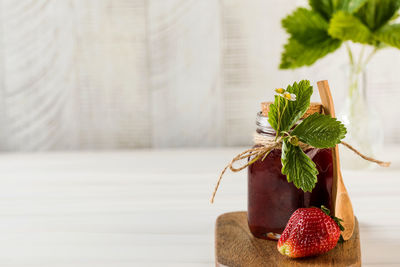 Close-up of strawberry and potted plant on table