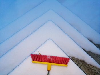 High angle view of snow covered roof against wall