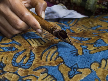 Cropped hand making batik design