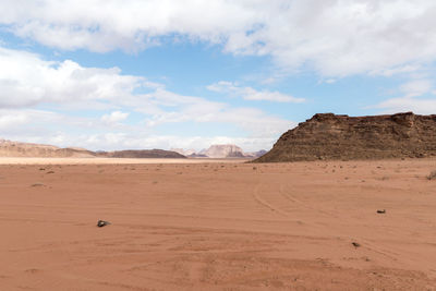 Sand dunes in desert against sky