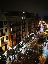 Crowd in illuminated city at night