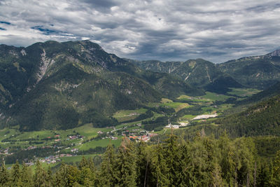 Scenic view of mountains and landscape against cloudy sky