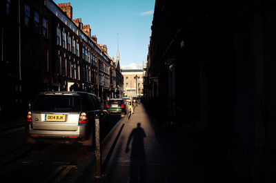 Vehicles on road along buildings