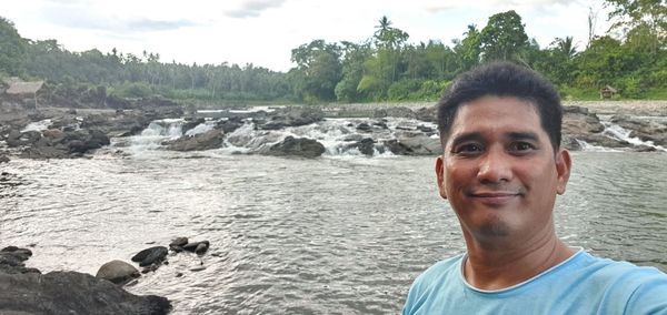 Portrait of smiling man on rock