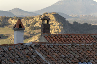 Stone wall of building with mountain in background