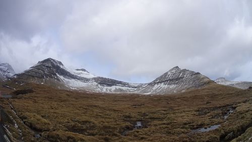 Scenic view of mountains against cloudy sky