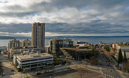 High angle view of buildings by sea against sky