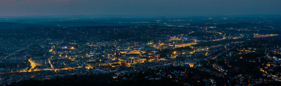 High angle view of illuminated city against sky at night