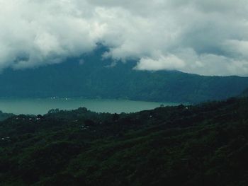 Scenic view of mountains against cloudy sky