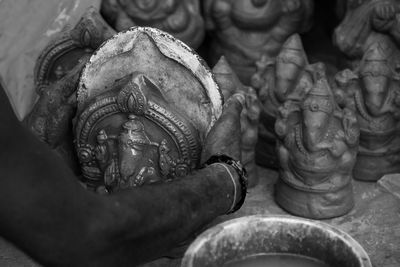Close-up of man making lord ganesha idol