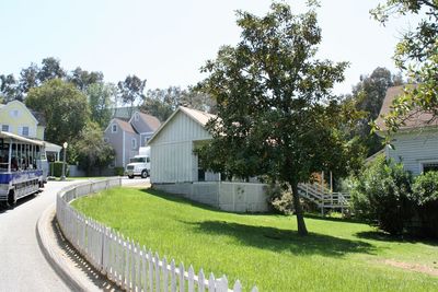 Trees by built structure against clear sky