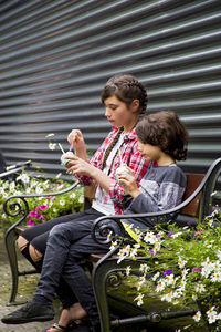 Siblings sitting on flower