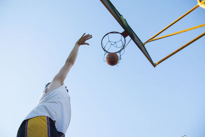 Low angle view of basketball player shooting the ball