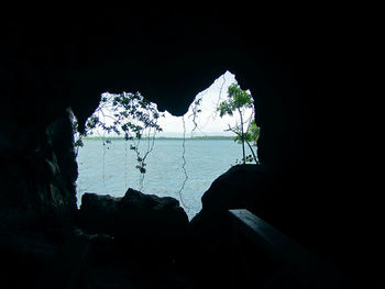 Scenic view of sea seen through cave