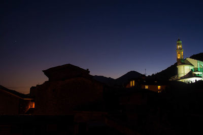 Silhouette of temple against clear sky at night