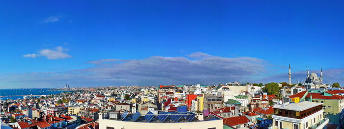 High angle view of town against blue sky