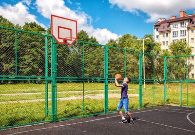 Young man playing basketball in court