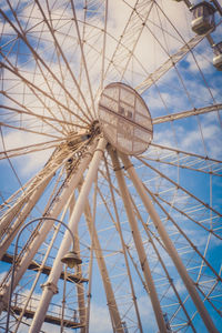 Low angle view of ferris wheel against blue sky