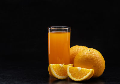 Close-up of orange juice against black background