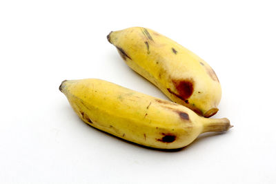 Close-up of bananas against white background