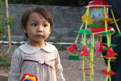 Portrait of cute girl standing outdoors