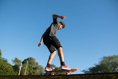 Portrait of skateboarder sliding