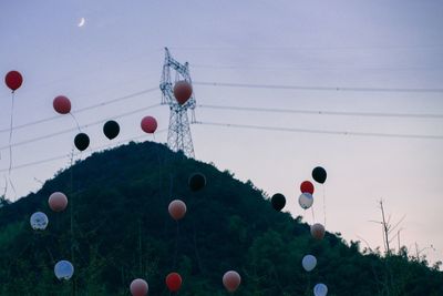 Low angle view of balloons against sky