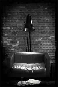 Electric lamp on brick wall