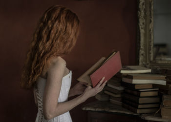 Woman reading book at home