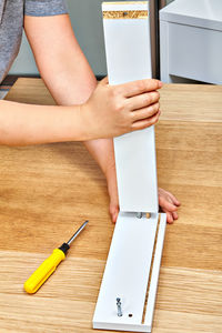 Low section of woman standing on wooden table