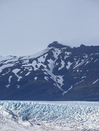 Scenic view of snowcapped mountains against clear sky