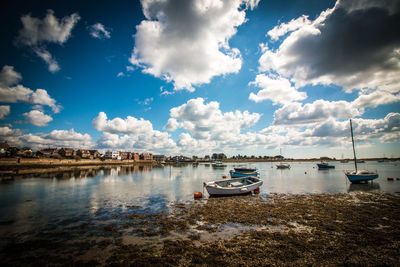 Boats in water against sky