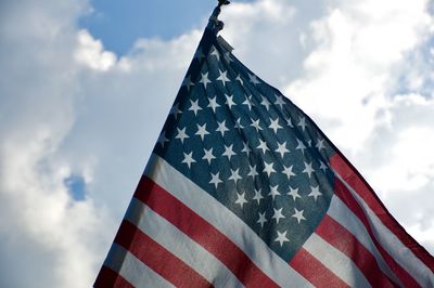 Low angle view of flag against blue sky