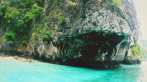 Scenic view of sea by rock formation