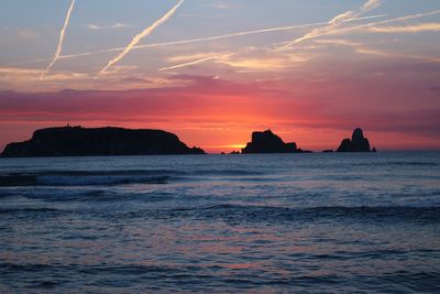 Scenic view of sea against romantic sky at sunset