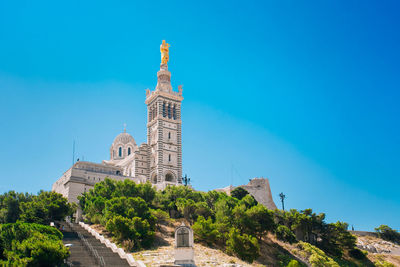 Low angle view of building against clear blue sky