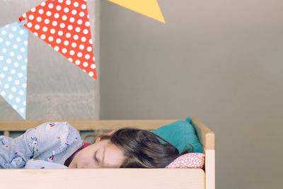 Cute girl sleeping on bed at home