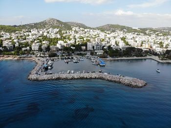 High angle view of city by sea against sky