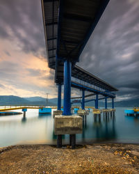 Bridge over river against sky during sunset